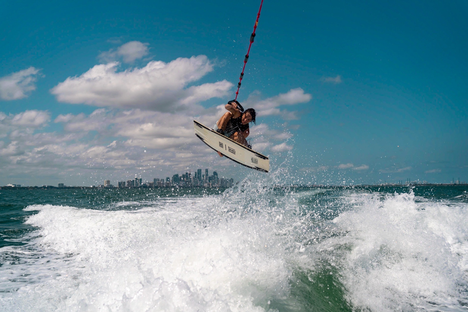 Wakeboarder jumping above the water in Miami