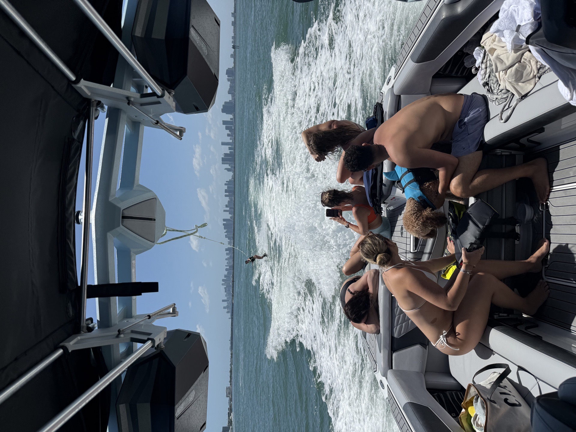 Group watching a wakesurf run from a private charter